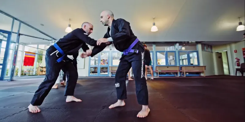 Adult Gi Jiu Jitsu Training – Mornington BJJ Classes Two men sparring in Gi during adult Brazilian Jiu-Jitsu training Mornington.