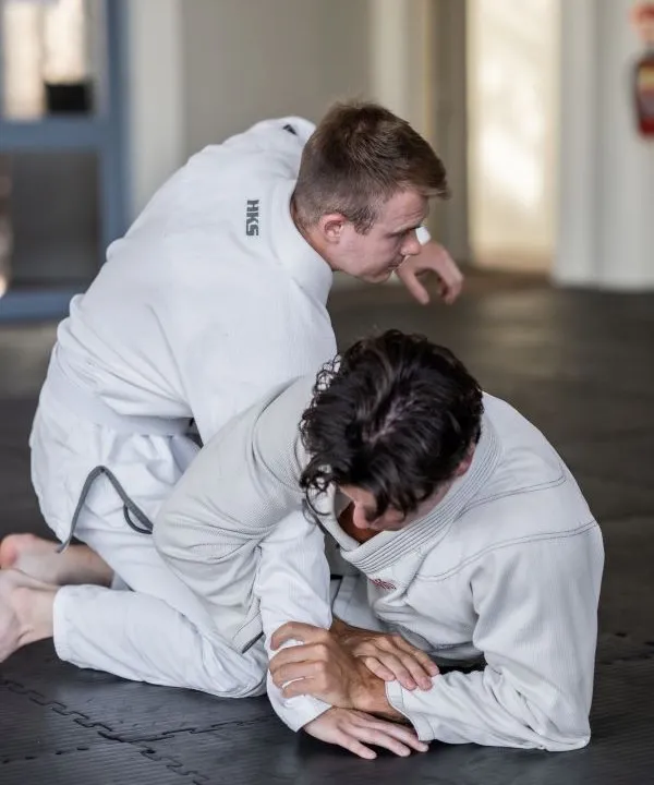 Two young men grappling in Gi during Brazilian Jiu Jitsu class at First Degree Jiu Jitsu Mornington.